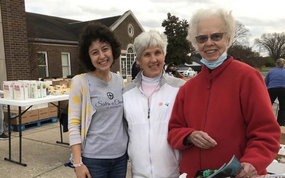 Julia Gerwe, left, embraces her call to serve with Srs. Susan Gatz, center, and Rosemarie Kirwan, at a November 2021 food distribution site in Nelson County, Kentucky, home of the Sisters of Charity of Nazareth. (Courtesy of Danielle Hagler)