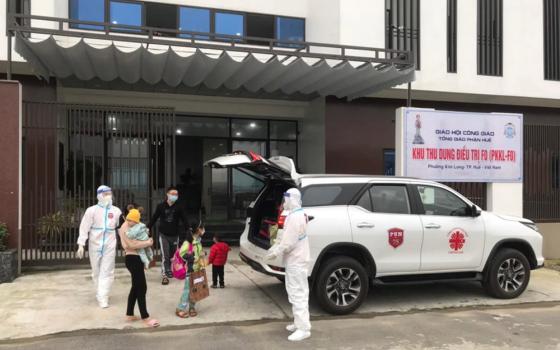 Religious volunteers in medical gear drive patients who have fully recovered from COVID-19 from Kim Long Charity Clinic in Kim Long ward in Hue, Vietnam, to their home Feb. 28. (Joachim Pham)