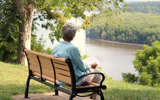 Sr. Lou Anglin of the Sisters of Charity of the Blessed Virgin Mary sits outdoors in quiet reflection in Dubuque, Iowa, as part of her participation in the Leadership Conference of Women Religious' 2020 virtual assembly. (Courtesy of LCWR)