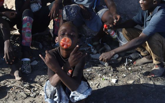 A child sniffs toxic glue from a plastic bottle on the streets of Mombasa, a coastal city in southeastern Kenya on the Indian Ocean. The high rate of youths using drugs has visibly affected their lives and the safety of the region. (GSR photo)