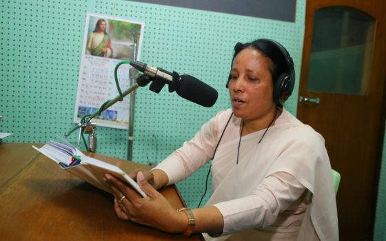 Sr. Mary Anna Gomes reads a script for a radio program for Radio Veritas Asia, Bengali Service. (Sumon Corraya)