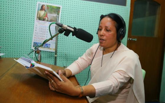 Sr. Mary Anna Gomes reads a script for a radio program for Radio Veritas Asia, Bengali Service. (Sumon Corraya)