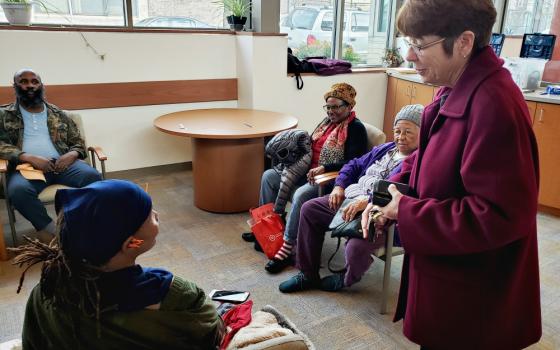 Mercy Sr. Mary Scullion, one of the co-founders of Project HOME in Philadelphia, meets clients at a Project HOME medical facility in December. (GSR photo/Chris Herlinger)