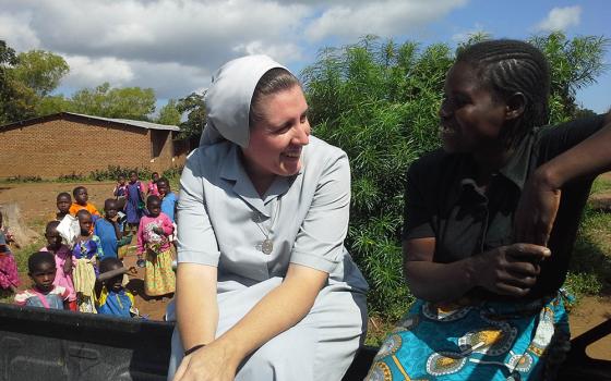 Canossian Sr. Melissa Dwyer and chats with one of her secondary students at Bakhita Secondary School in Balaka, Malawi, in 2009. (Courtesy of Melissa Dwyer)