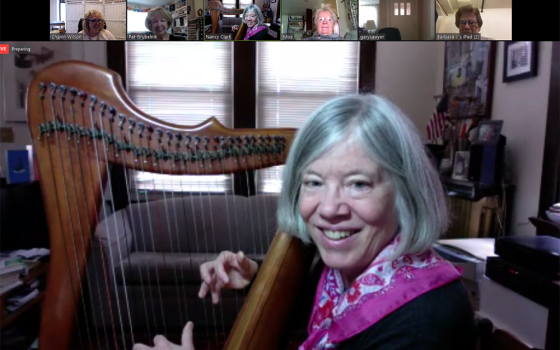 Nancy Bick Clark, an associate with the Sisters of Charity of Cincinnati, Ohio, plays the harp during a Zoom commitment ceremony in March 2020 for new associate Jean Simpson. (Courtesy of the Sisters of Charity of Cincinnati)