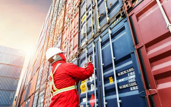 A seafarer checks containers in this photo illustration. Seafarers are responsible for delivering most food, medicine, and electronics around the world, but disembarking at most international ports has become an impossibility. (Courtesy of Solidarity with