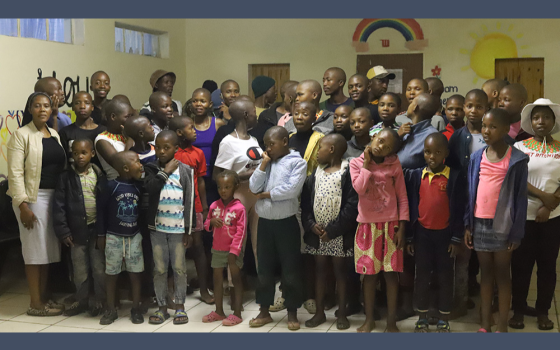 Sr. Eusebia Maselitso Lerotholi, a member of Handmaids of Christ the Priest, with the children at Andrew Blais Orphanage Home. Lerotholi founded the orphanage in 2013 to help homeless and orphaned children have a home and access to education. (GSR)