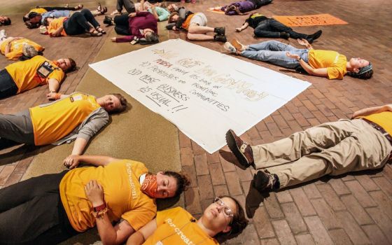 Members of Friends of Fossil Free PCUSA symbolically portray deaths over the next several years in protest of General Assembly 223 voting to not immediately divest from the fossil fuel industry on June 22, 2018, in St. Louis. (RNS/PCUSA/Danny Bolin)
