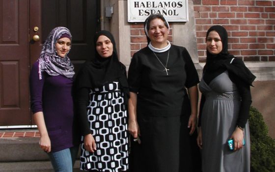 Sister Doretta, Apostle of the Sacred Heart of Jesus, poses with clients of the community immigrant services center in New Haven Connecticut. (Apostle Immigrant Services)