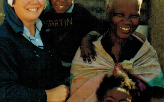 Mercy Sr. Jean Evans with a village family (Provided photo)