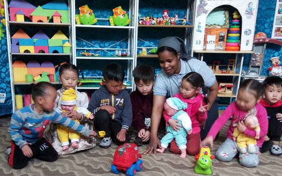 Sr. Tireza Gabriel Usamo plays with children at a day care center run by Consolata Missionaries. (Courtesy of Tireza Gabriel Usamo)