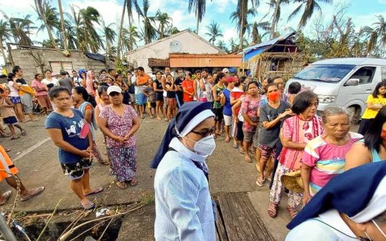A Mercy sister oversees the distribution of relief goods in San Francisco, Southern Leyte. (Courtesy of the Religious Sisters of Mercy)