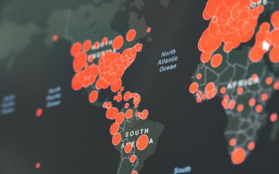 World map showing red circles of coronavirus infections