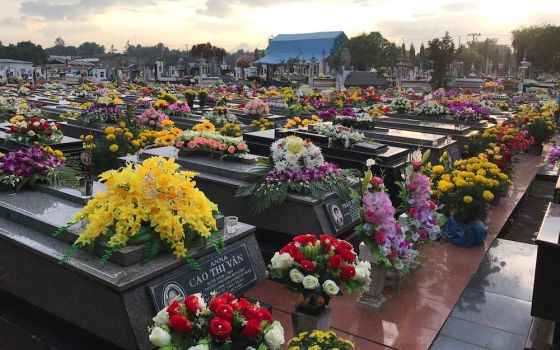 The graves of a parish cemetery in Ho Chi Minh are decorated with flowers in November. (Nguyen)