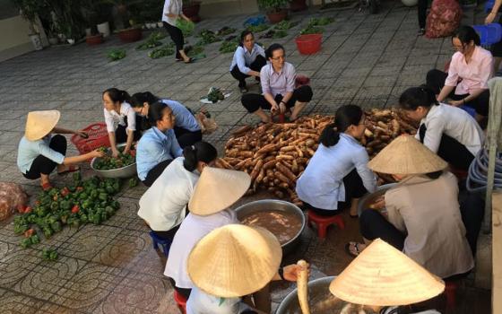 Dominican sisters in Ho Chi Minh City, Vietnam, prepare raw fruits and roots in their motherhouse's yard before giving them to people affected by COVID-19. (Courtesy of Mary Nguyen Thi Minh Du)