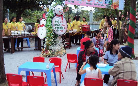 Lovers of the Holy Cross nuns hold a "Christmas market" serving food with budget prices to local people on Dec. 12 at Pho Thach Parish in Phong Dien District of Thua Thien Hue Province, Vietnam. (Peter Nguyen)