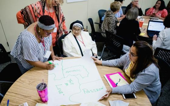 Participants work on a poster at a curriculum workshop for Called and Consecrated in 2018 at the Oblate School of Theology in San Antonio. The curriculum teaches middle and high schoolers about the Catholic faith through the lives of women religious.