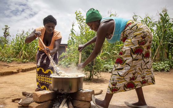 Volunteers for Catholic Relief Services in Zambia preparing a demonstration meal, stressing the need to use local crops and ingredients in meals. (Catholic Relief Services/Dooshima Tsee)