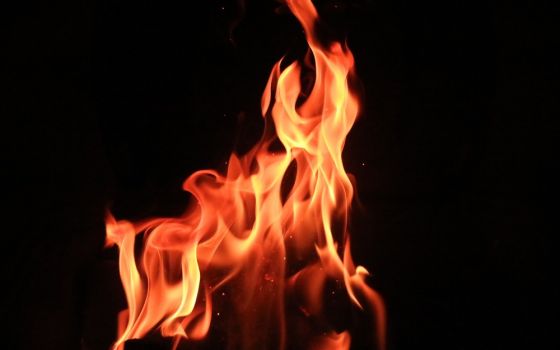 A fire burns against a black background
