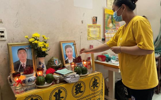 A 16-year-old girl in Ho Chi Minh City, Vietnam, prays for her parents lost in the COVID-19 pandemic this year. (Nguyen)