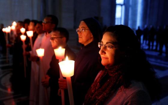 Religious hold candles as Pope Francis celebrates Mass on Feb. 2, 2017, to mark the feast of the Presentation of the Lord in St. Peter's Basilica at the Vatican. In a video message released by the pope's Worldwide Prayer Network on Feb. 1.