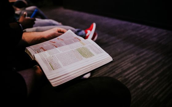 Woman reads a highlighted Bible