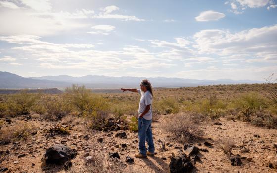 Cholla Canyon Ranch caretaker Ivan Bender points out the boundaries of the Hualapai Tribe's property from one of the initial exploratory drilling sites surrounding the ranch. (Roberto (Bear) Guerra/High Country News)