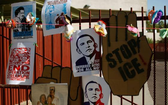 Protesters' signs hang at the entrance of the Immigration and Customs Enforcement headquarters in Phoenix Oct. 14, 2013. (Newscom/Reuters/Joshua Lott)