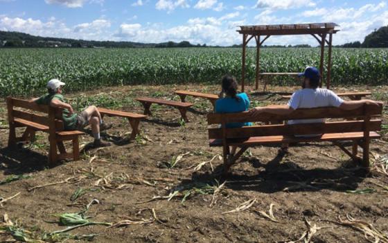 People sit at an outdoor chapel on the property of the Adorers of the Blood of Christ in 2017 in Columbia, Pennsylvania. (CNS/Mark Clatterbuck, courtesy Lancaster Against Pipeline) 