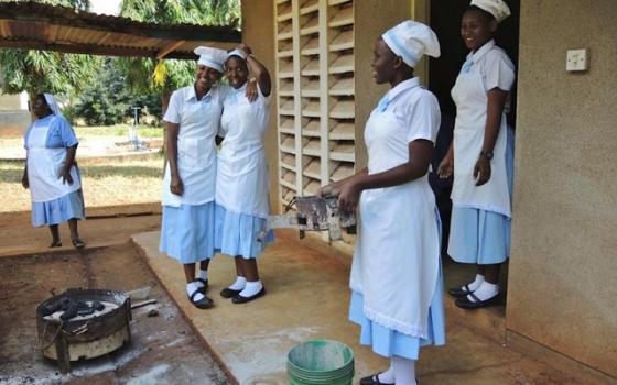 Students at the Bigwa Secondary School in their cooking class, which includes nutrition and hygiene. (GSR/Melanie Lidman)