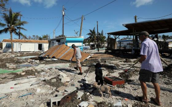 Men walk in a destroyed mobile home park Sept. 12 in the aftermath of Hurricane Irma in the Florida Keys. (CNS/Carlos Barria, Reuters)