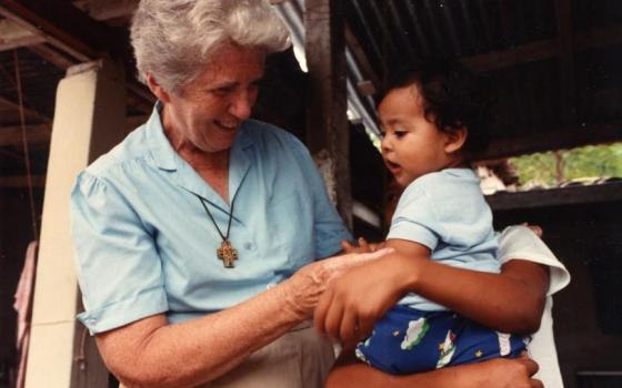 Sr. Madeline Dorsey with a child in El Salvador in the late 1970s. (Used with permission of Maryknoll Sisters)