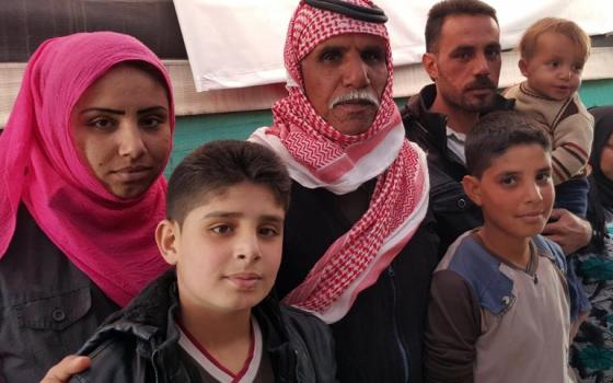 The family of Abdel Karim, third from left, who fled the city of Aleppo, Syria, in 2012 and are living, as many Syrian refugees do, in tents. In their case, they are staying not far from the city of Zahle, Lebanon. (GSR/Chris Herlinger)