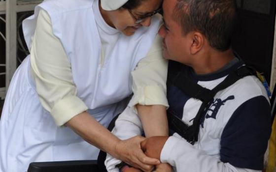 Sr. Dolores Ochoa hugs a developmentally disabled 28-year-old at the Home of Marina Leal Guirola a, an orphanage run by Somoscan Missionary Sisters. Many of children are abandoned at birth and it is left to the church to provide for their care. (GSR photo / J. Malcolm Garcia)