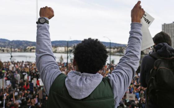 A demonstrator in Oakland, California, protests Dec. 13, 2014, against police violence. (CNS/Reuters/Stephen Lam)