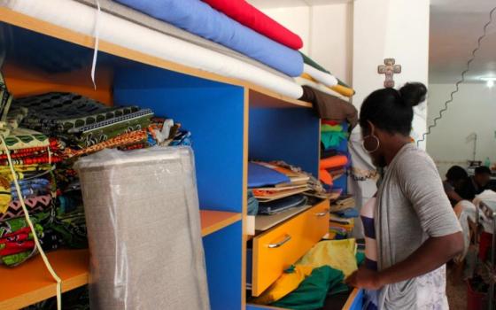 Mary pulls out fabric to make products for the newHope cooperative in a convent in Italy. In the coop's workshop, former victims of trafficking gain job skills, a work contract, and dignity from creating the products. (Megan Sweas)