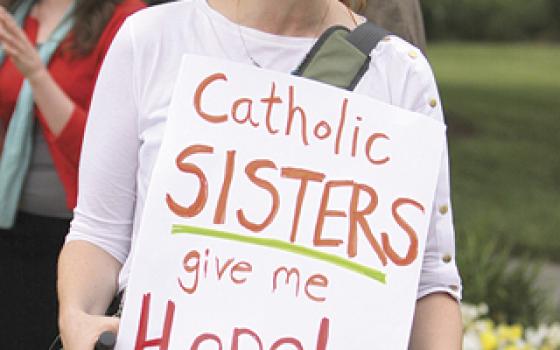 A protester joins others in front of the U.S. Conference of Catholic Bishops building in Washington, D.C., on May 8, 2012, in support of Catholic sisters. (Ted Majdosz)