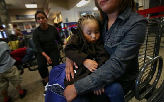 Janet Perez of Guatemala holds her daughter, Ariana,3, after being released from the South Texas Family Residential Center in Dilley, Texas, on July 14. She and other immigrants were at the Greyhound bus station in San Antonio waiting for buses that would take them to be reunited with family and friends. (GSR/Nuri Vallbona)