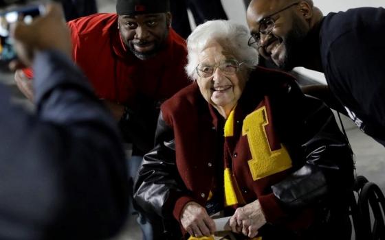 Loyola-Chicago basketball chaplain Sister Jean Dolores Schmidt, poses with fans for a photo before the first half of a regional final NCAA college basketball tournament game on March 24, 2018, in Atlanta. (AP/David Goldman)