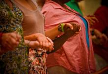 Congregants hold hands and pray during Mass in a 2016 file photo. (CNS/Catholic Herald/Juan C. Medina)