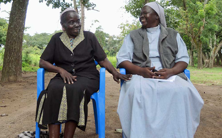  Angelika Ouma, left, the director of the Bishop Caesar Asili Memorial Nursery and Primary School, and head teacher Sr. Laura Kaneyo sit outside the school.