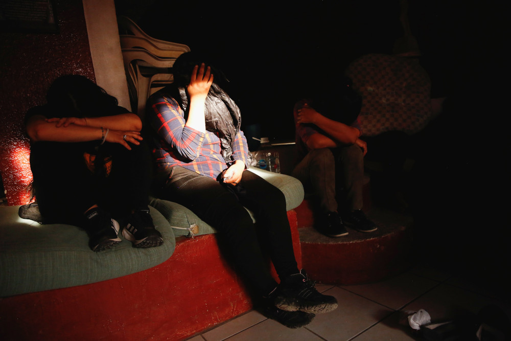 Migrants from Central America are seen inside a house in Ciudad Juarez, Mexico, June 9, after being rescued by the police from human smugglers. (CNS/Reuters/Jose Luis Gonzalez)